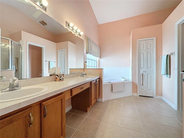 4634 Summerbridge Cir, Leesburg, FL 34748 - full bathroom featuring vaulted ceiling, tile patterned flooring, a shower stall, double vanity, and a bath
