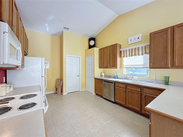 kitchen featuring light tile patterned floors, white appliances, vaulted ceiling, and sink