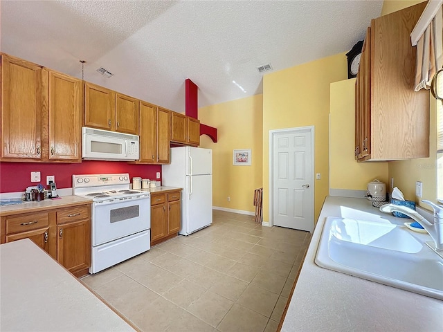 kitchen featuring vaulted ceiling, a textured ceiling, white appliances, and sink