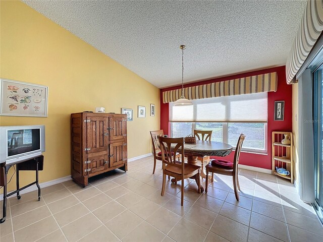 4634 Summerbridge Cir, Leesburg, FL 34748 - dining room featuring a textured ceiling, lofted ceiling, light tile patterned floors, and baseboards