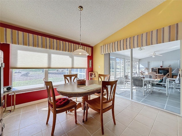 dining room with tile patterned flooring, ceiling fan, a healthy amount of sunlight, and lofted ceiling