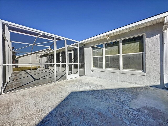 4634 Summerbridge Cir, Leesburg, FL 34748 - rear view of property with a patio and glass enclosure