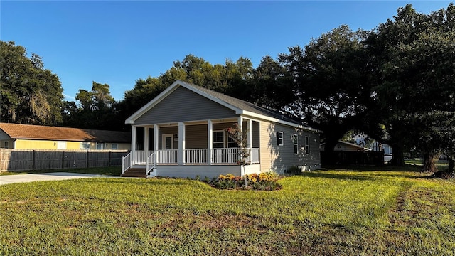 view of front of property with a porch and a front yard