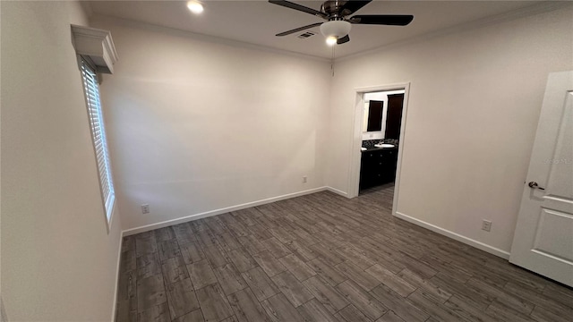 unfurnished room with ceiling fan, crown molding, and dark wood-type flooring