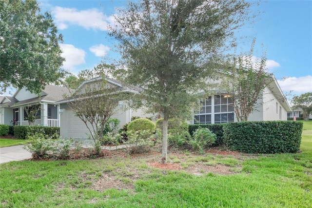 obstructed view of property featuring a front yard and a garage