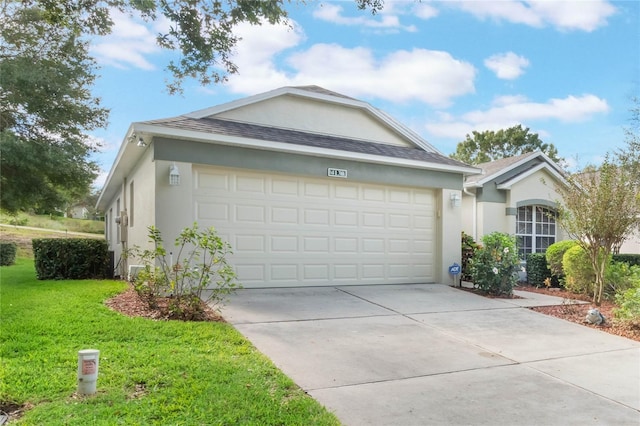 view of front of property with a front yard and a garage