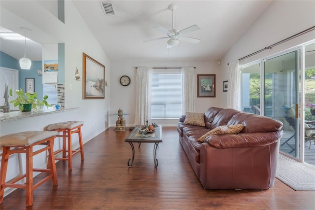 4130 Capland Ave, Clermont, FL 34711 - living room featuring vaulted ceiling, wood finished floors, plenty of natural light, ceiling fan, and baseboards