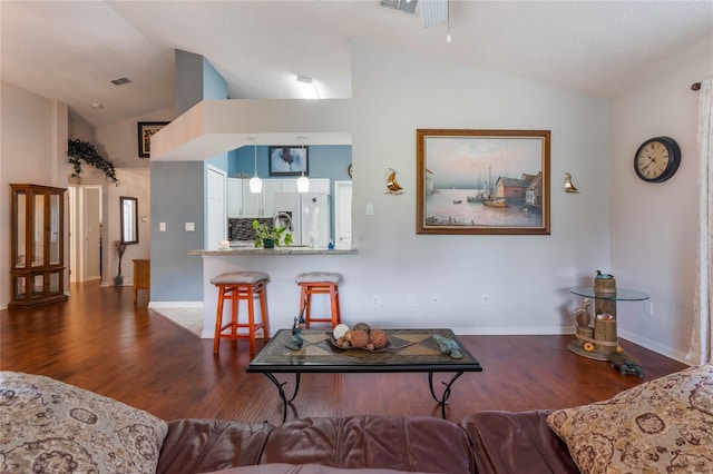 4130 Capland Ave, Clermont, FL 34711 - living area featuring vaulted ceiling, dark wood-style flooring, and baseboards