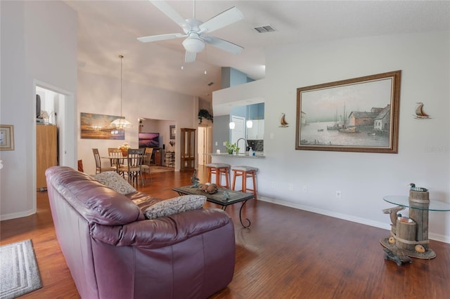 4130 Capland Ave, Clermont, FL 34711 - living room with a ceiling fan, wood finished floors, baseboards, and high vaulted ceiling