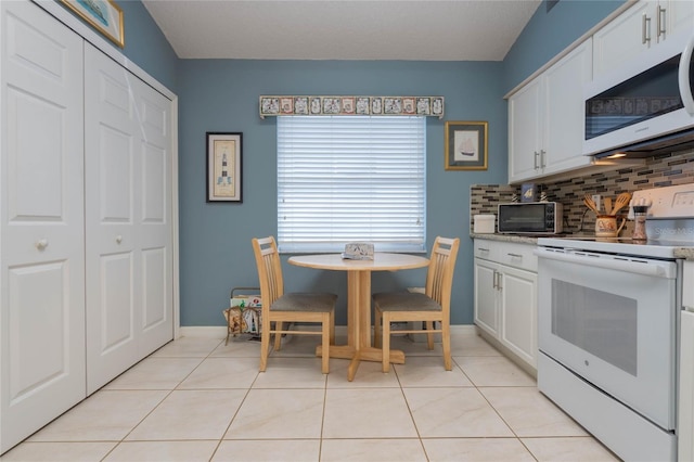 4130 Capland Ave, Clermont, FL 34711 - dining area featuring light tile patterned floors and baseboards