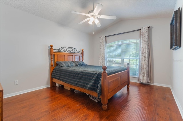 bedroom featuring a textured ceiling, ceiling fan, dark wood-type flooring, and vaulted ceiling