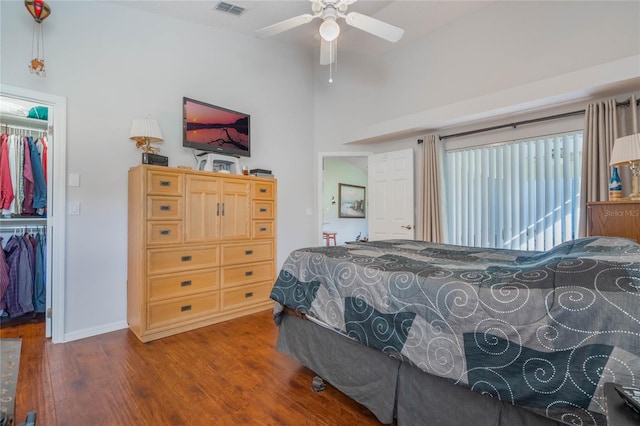 4130 Capland Ave, Clermont, FL 34711 - bedroom with a walk in closet, wood finished floors, a closet, and baseboards