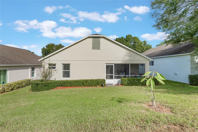 4130 Capland Ave, Clermont, FL 34711 - rear view of house featuring a lawn, a sunroom, and stucco siding