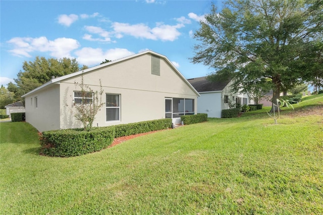 4130 Capland Ave, Clermont, FL 34711 - rear view of house featuring stucco siding and a lawn