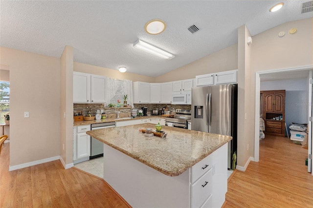 kitchen featuring a center island, white cabinets, and appliances with stainless steel finishes