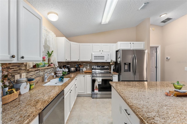 kitchen with white cabinetry, sink, lofted ceiling, and stainless steel appliances