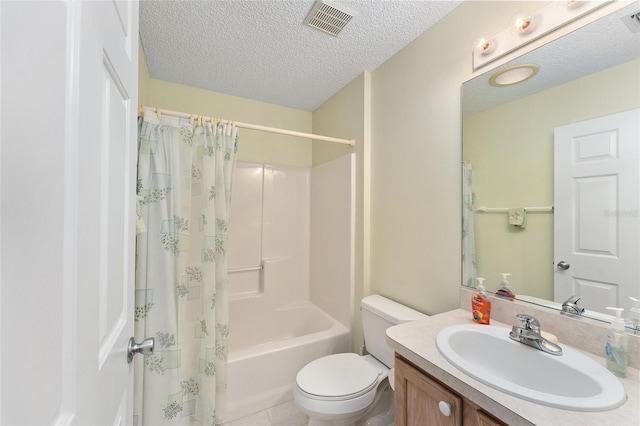 full bathroom featuring vanity, tile patterned flooring, toilet, shower / bath combo with shower curtain, and a textured ceiling