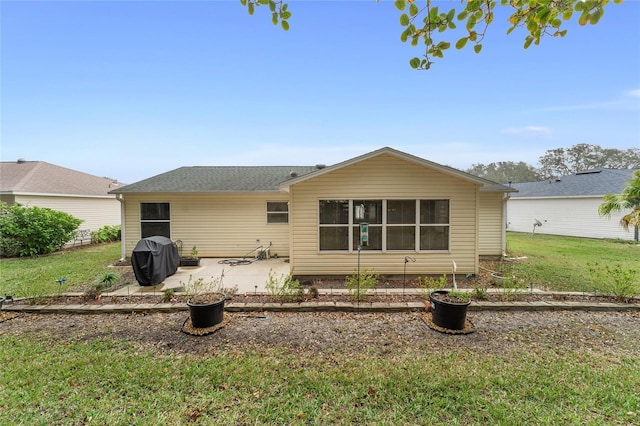 back of property featuring a lawn and a patio area