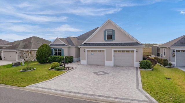 view of front of home featuring a front lawn and a garage