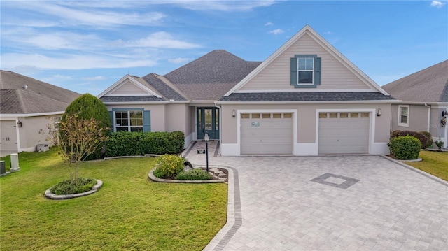 view of front of property featuring a garage and a front lawn