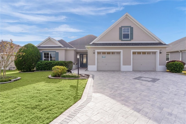 view of front of house with a front yard and a garage