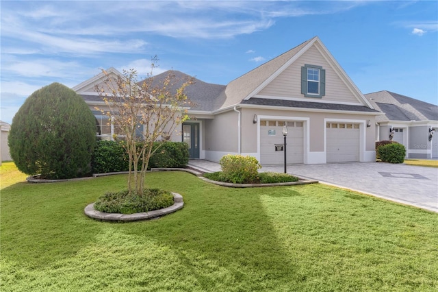 view of front of house featuring a garage and a front lawn