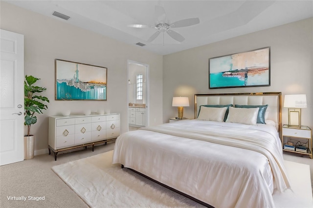 carpeted bedroom featuring ensuite bathroom and ceiling fan