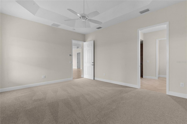 unfurnished room with ceiling fan and light carpet