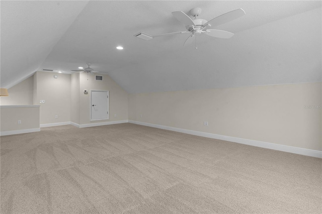 bonus room with ceiling fan, light carpet, and vaulted ceiling