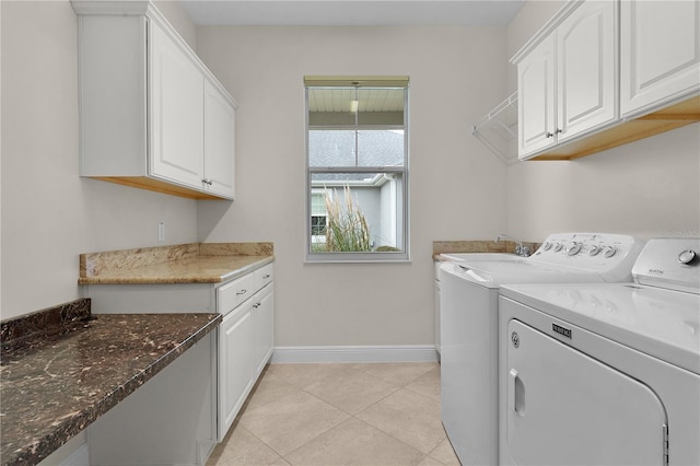 laundry room with cabinets, independent washer and dryer, and light tile patterned floors