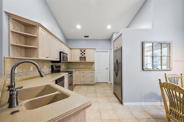 kitchen with sink, tasteful backsplash, vaulted ceiling, light brown cabinetry, and appliances with stainless steel finishes