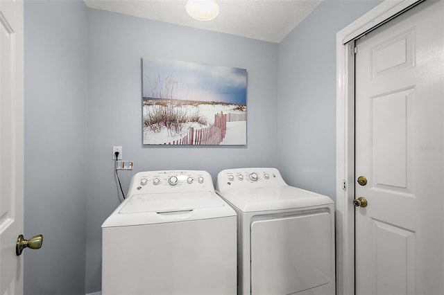 washroom featuring washer and dryer and a textured ceiling