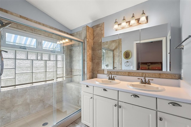 bathroom featuring tile patterned floors, vanity, lofted ceiling, and walk in shower