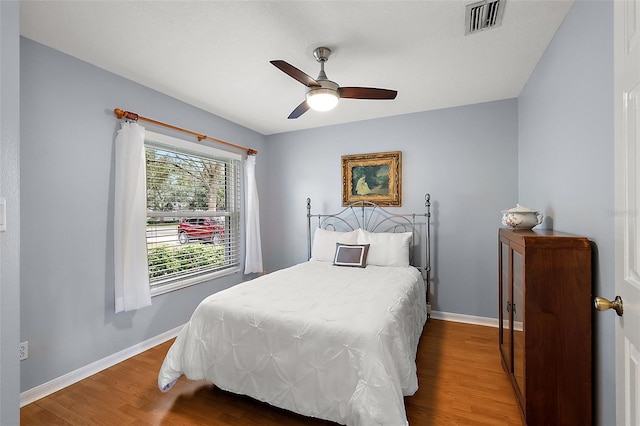 bedroom featuring hardwood / wood-style floors and ceiling fan