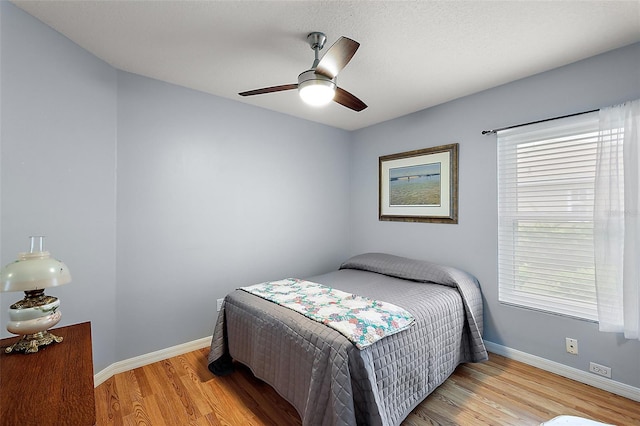 bedroom with ceiling fan and light hardwood / wood-style floors