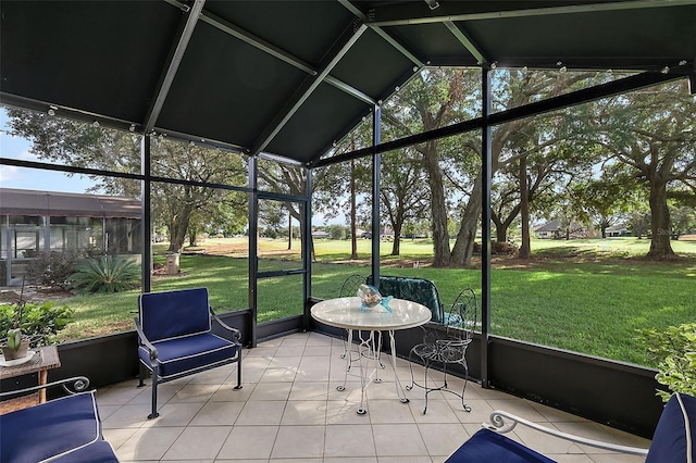 unfurnished sunroom featuring vaulted ceiling