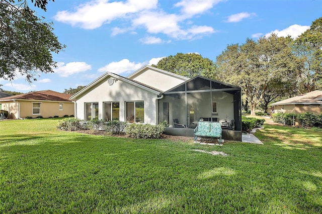 back of property featuring a lawn and a lanai