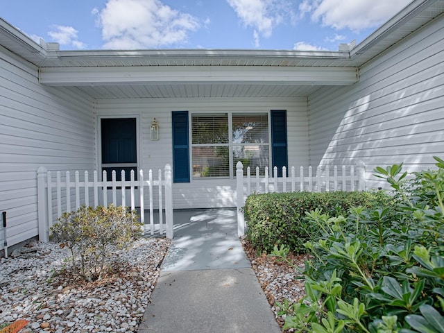 view of exterior entry with covered porch