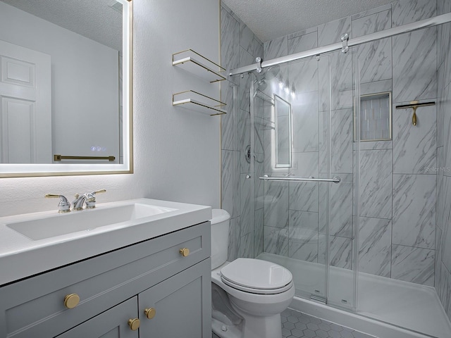 bathroom featuring vanity, toilet, a textured ceiling, and walk in shower