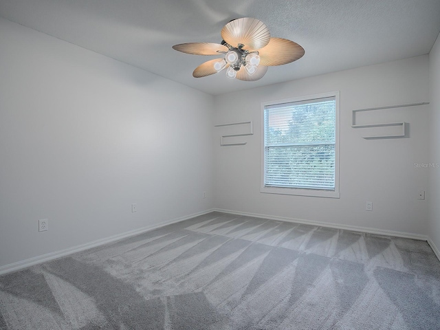 empty room featuring carpet floors and ceiling fan