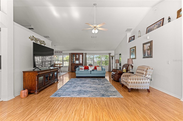 living room with ceiling fan, light hardwood / wood-style flooring, and lofted ceiling