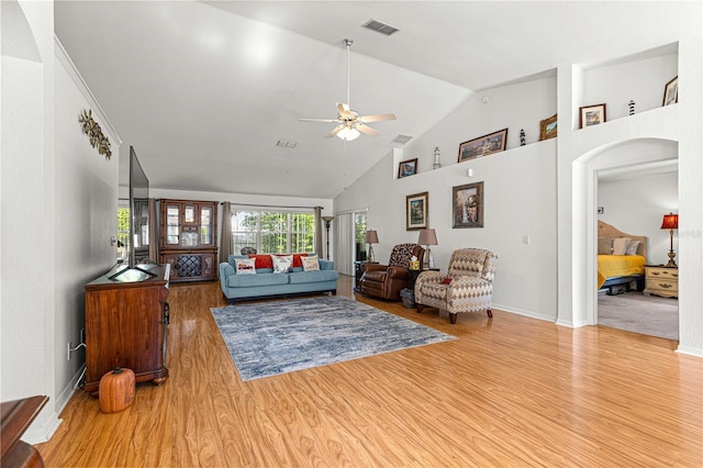 living room with ceiling fan, high vaulted ceiling, and light hardwood / wood-style flooring