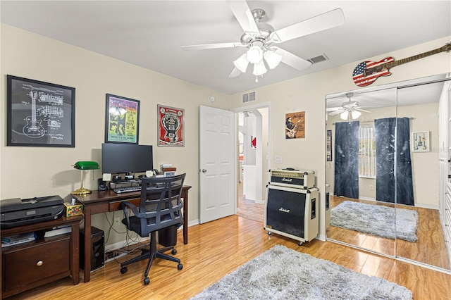 home office with ceiling fan and light hardwood / wood-style floors