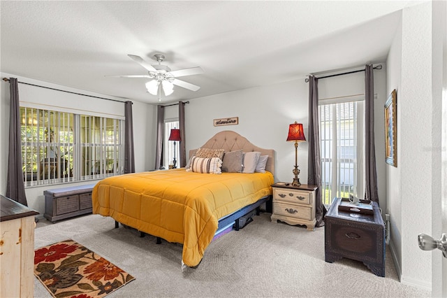 bedroom with ceiling fan and light carpet