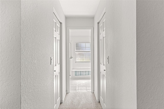 hallway with light colored carpet