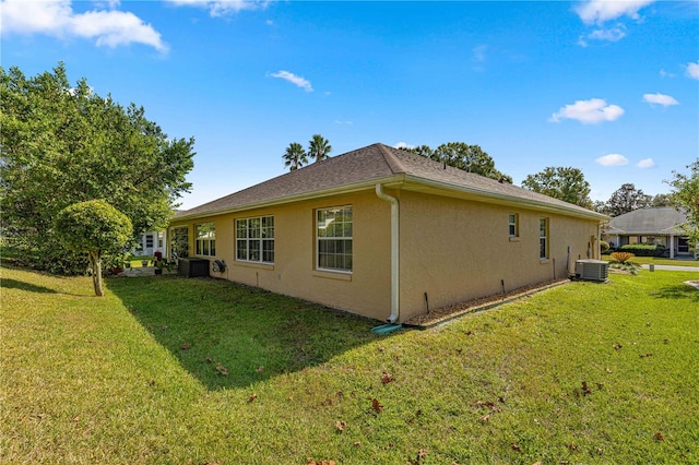 view of property exterior with cooling unit and a lawn