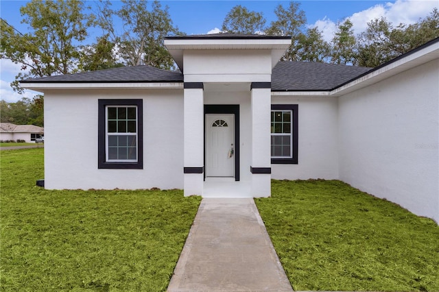 entrance to property featuring a yard