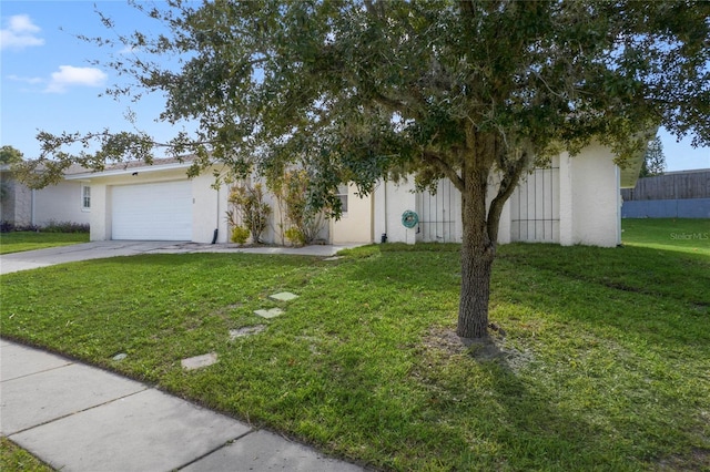 obstructed view of property with a front yard and a garage