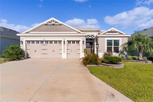 view of front of house featuring a garage and a front lawn