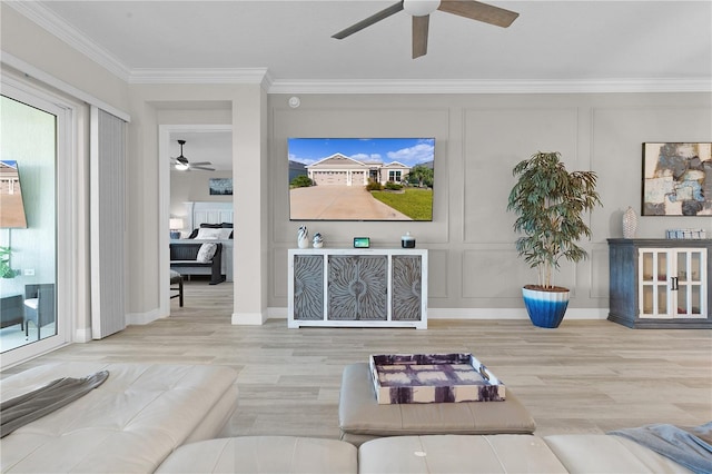 living room with hardwood / wood-style floors, a healthy amount of sunlight, and ornamental molding